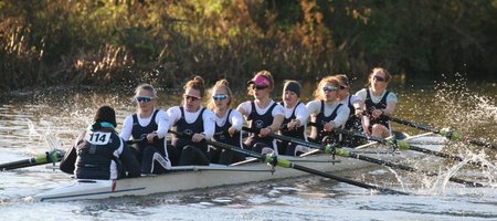 The winning women's 8+ from the event racing down first post reach