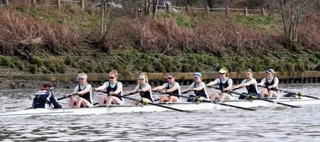 The winning women's eight racing along the Tideway